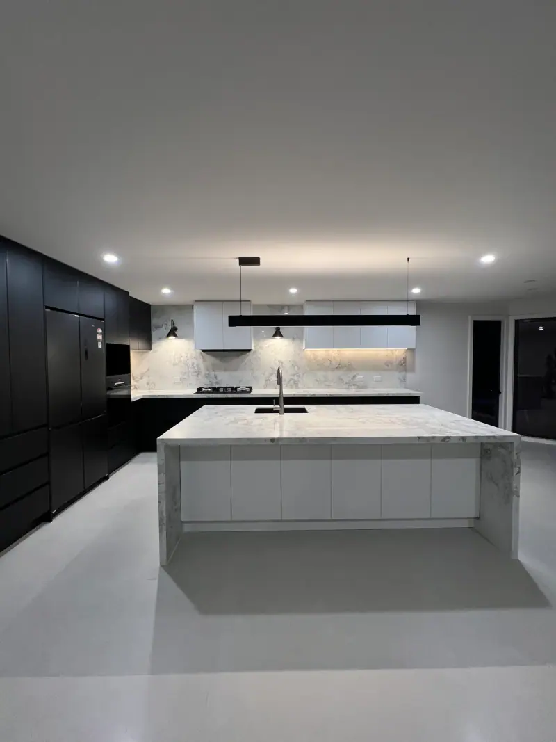 Burwood East black and white kitchen with marble-look waterfall island